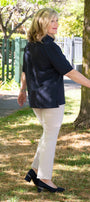 Side view navy top and white pants 