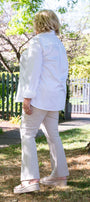 Person wearing a white shirt and light-colored pants .