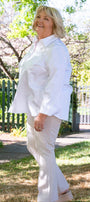 Person wearing a white shirt and beige pattened pants outfit .