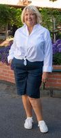 Front view  white shirt and navy shorts .