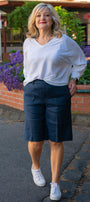 Front view a white top and navy shorts 