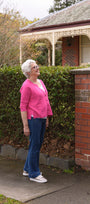 Woman in pink sweater and blue jeans .