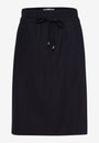 Front view A black Peggy Skirt Raphaela with a straight silhouette and high rise waist.