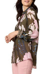 Woman wearing a floral blouse with a white background