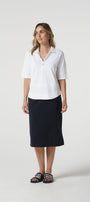 Woman wearing a white shirt and black skirt on a white background