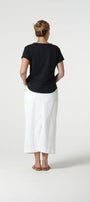 Back view black cotton t-shirt and white pants.