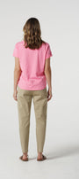 Back view pink cotton  t-shirt and beige pants.