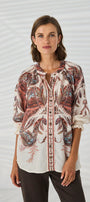 loose, long sleeve tunic top with a multicolor abstract pattern in shades of pink, beige, and brown.