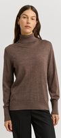 Woman wearing a brown turtleneck sweater on a white background