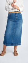 A person standing wearing a blue denim maxi skirt with a belt and sandals. The skirt has a high waist and features reinforcement stitching, a 5 pocket design, and a zip fly opening.