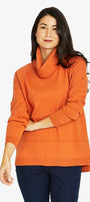 Woman wearing an orange cowl-neck sweater.