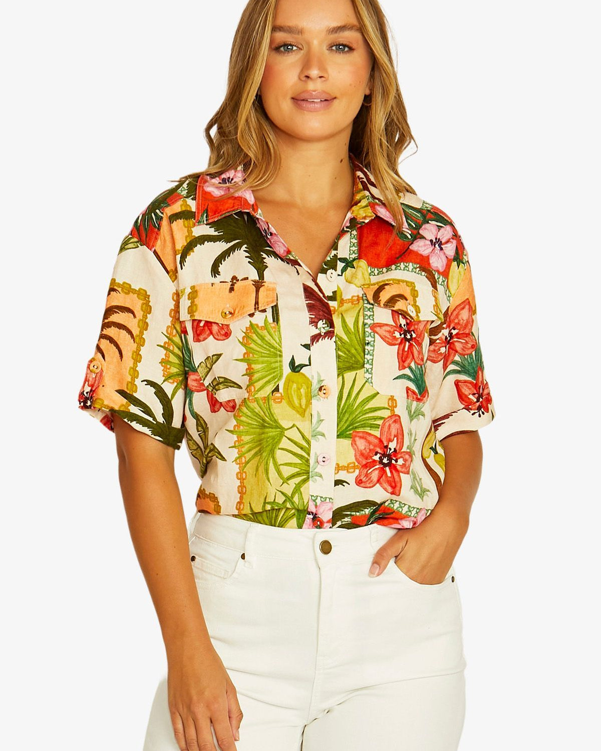 Front View  short sleeve button up shirt with a vibrant tropical floral and tiger print, paired with white pants.