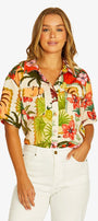 Front View  short sleeve button up shirt with a vibrant tropical floral and tiger print, paired with white pants.