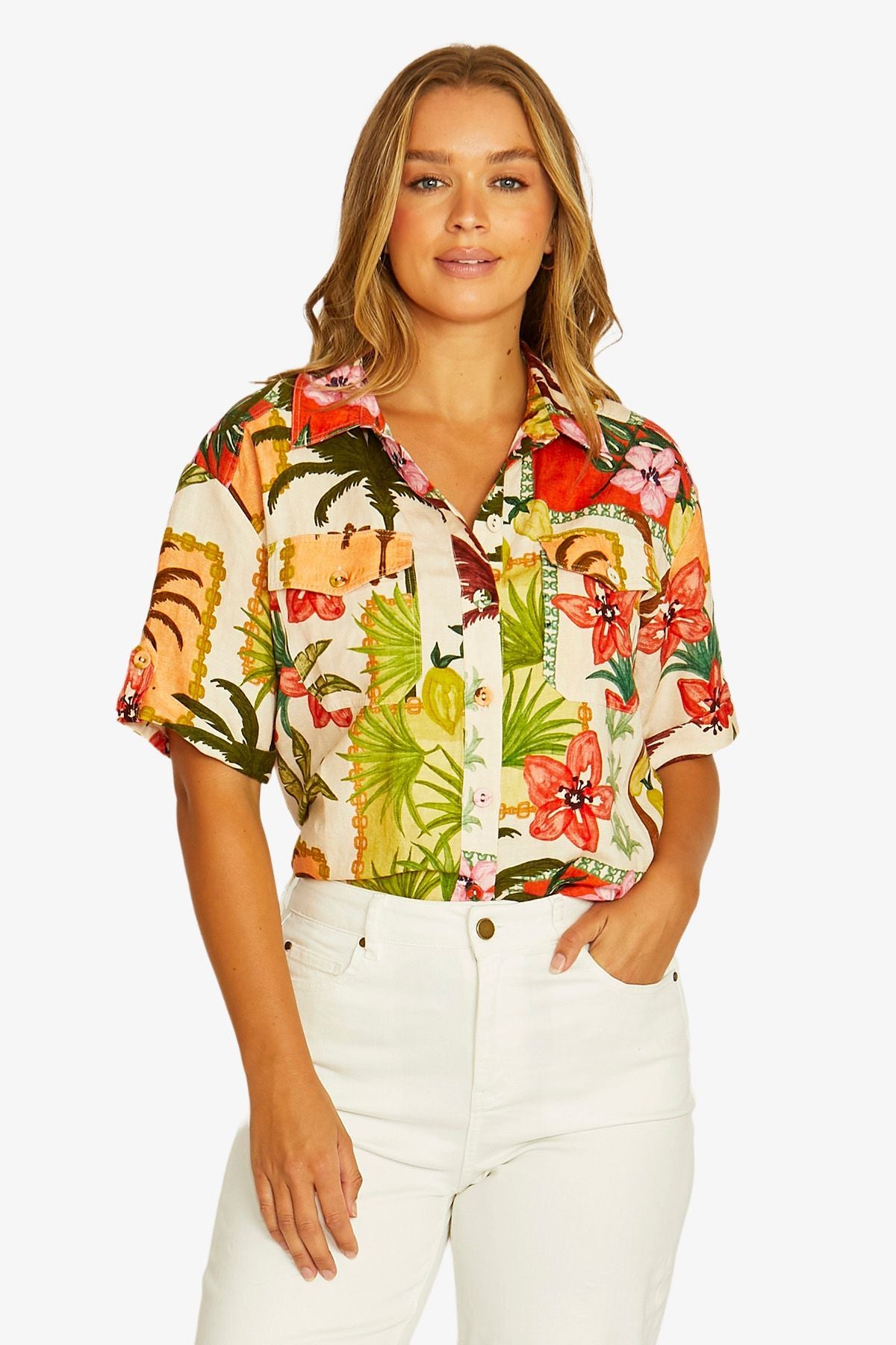 Front View  short sleeve button up shirt with a vibrant tropical floral and tiger print, paired with white pants.