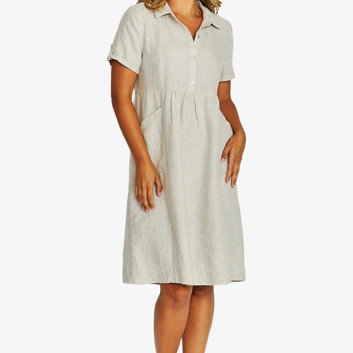 front View  light beige linen shirt dress with short sleeves, a button down collar, and a gathered waist, paired with beige strappy sandals.