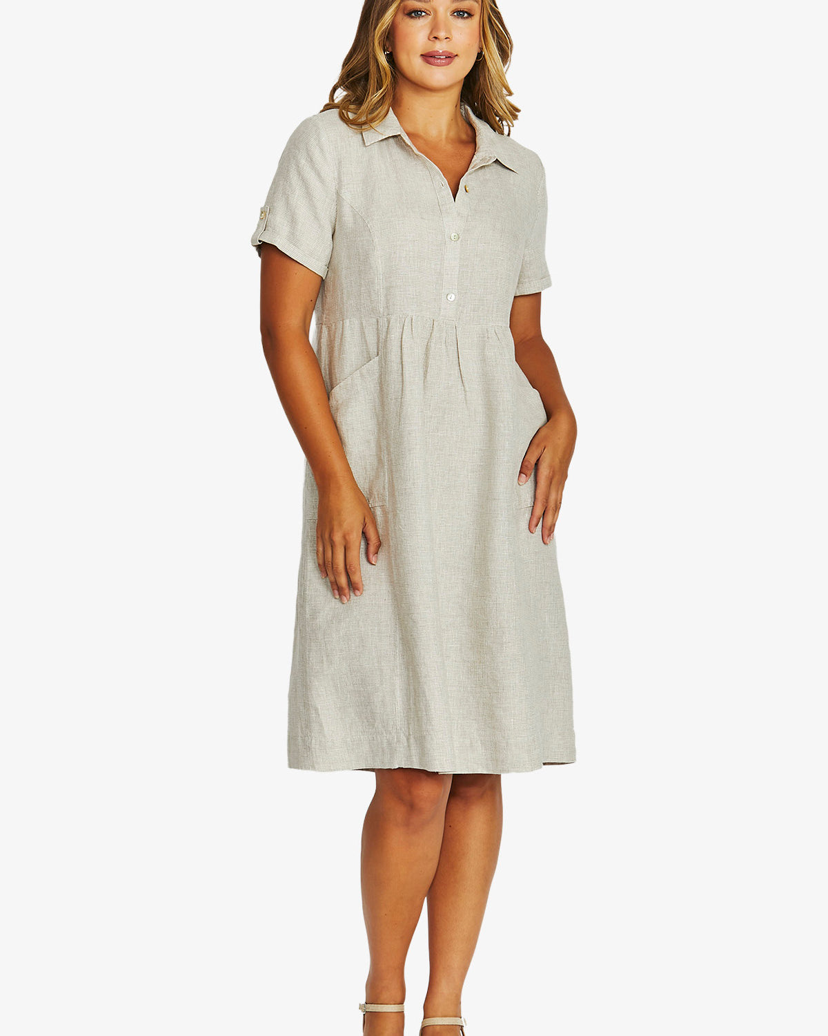 front View  light beige linen shirt dress with short sleeves, a button down collar, and a gathered waist, paired with beige strappy sandals.