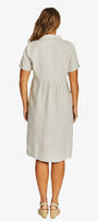 Back view  wearing a light beige short sleeve linen dress with a collar and gathered waist, paired with beige sandals.