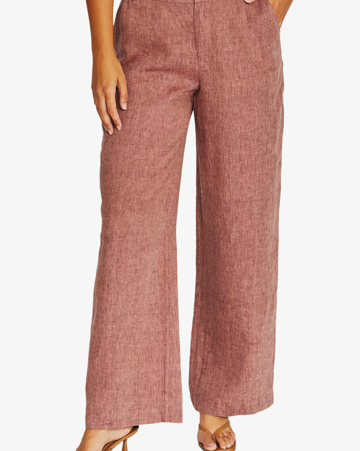 Front view dusty rose wide leg trousers with a textured linen like fabric, paired with a white top and tan heeled sandals, 