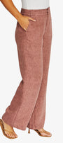 Side view dusty rose wide leg pants with a textured linen like fabric, paired with a white top and tan heeled sandals.