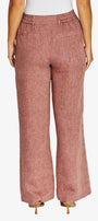Back View waist down wearing dusty rose wide leg trousers with a textured linen like fabric, paired with a white top and beige heels.