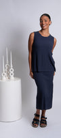Front view wearing a sleeveless, navy colored top with a step rib design.
