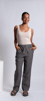 Front  view beige tank top and gray trousers.