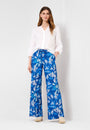 Front view a white long sleeve V-neck shirt with blue floral print pants.