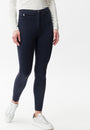Front view navy coloured skinny pants and a white top, paired with white sneakers.