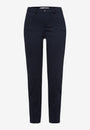 Front view navy coloured skinny pants and a white top, paired with white sneakers.