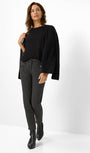 Front view a black oversized sweater and checkered pants.