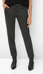 Person wearing black and white checkered pants with black boots.