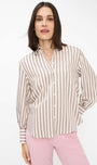 Woman wearing a striped shirt and pink pants .
