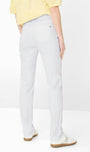 White straight-leg trousers shown on a model from the back, paired with a yellow top and white sneakers, against a clean white studio background.
