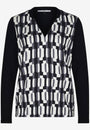 Front view a black and white geometric patterned top with long sleeves.