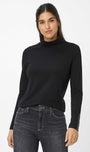 Front view a black turtleneck  top and gray jeans.