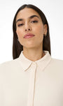 Woman wearing a beige blouse 