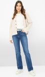 Front view  a cream cardigan, white shirt, blue jeans, and white shoes.