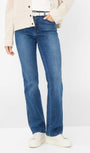 Front view blue jeans and a cream jacket.
