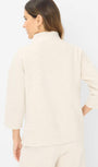 Back view a cream colored top 