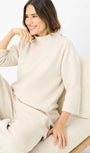 Woman wearing a beige outfit .