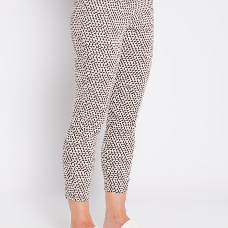 Person wearing patterned pants on a white background