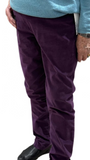 Person wearing a blue sweater and purple pants .