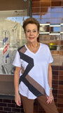 Woman wearing a v neck tee with mocha and black zig zag stripe.
