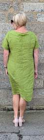 back view of a short sleeved lime green midi dress and light pink heels.