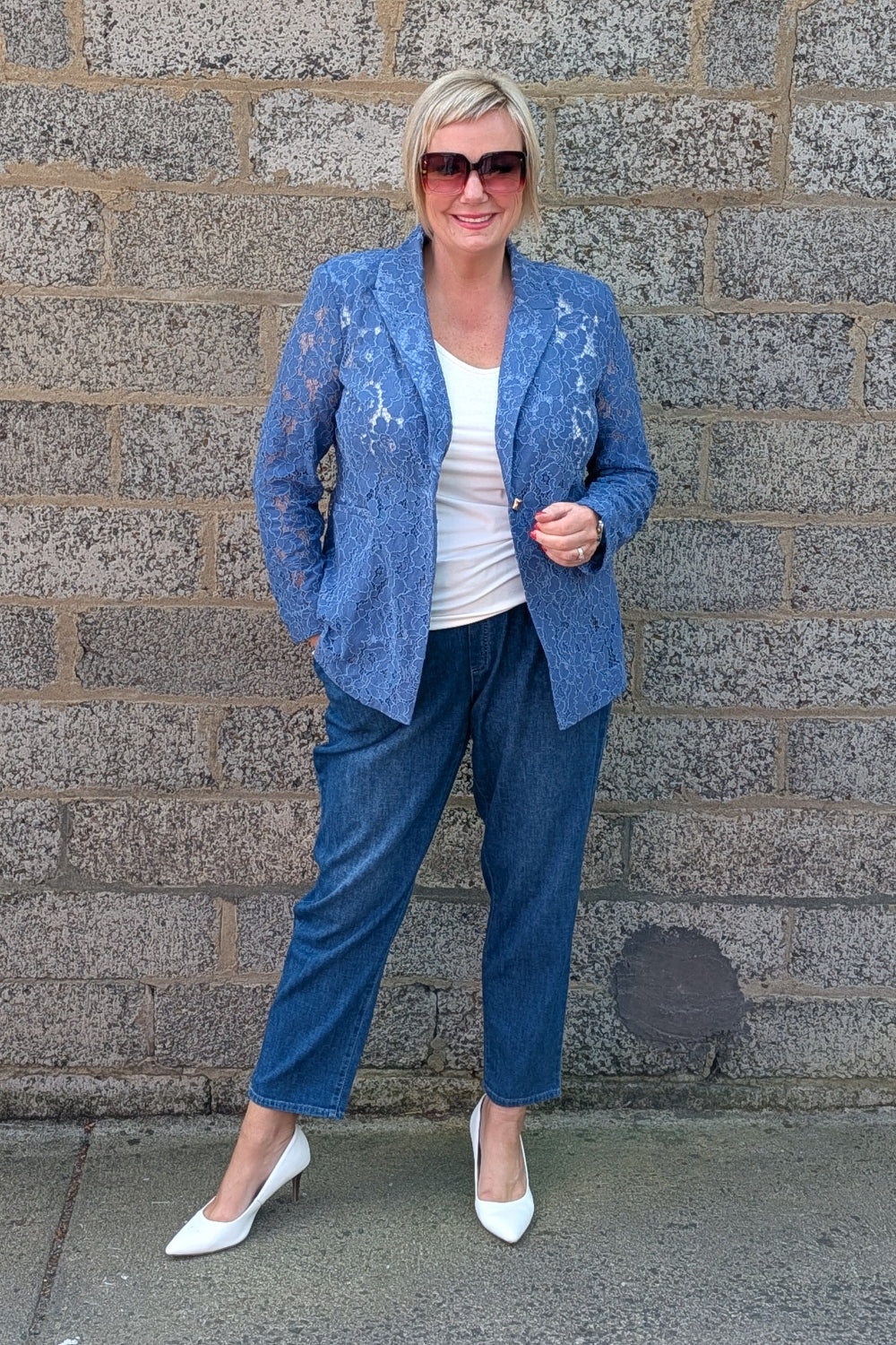 lace trimmed blazer, cobalt cropped pants, a white top, and white pointed-toe heels.