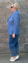 Cobalt lace blazer, blue jeans, and white pointed shoes.