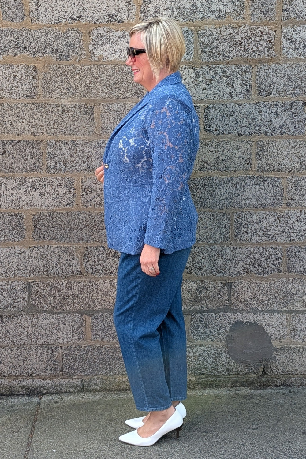 Cobalt lace blazer, blue jeans, and white pointed shoes.