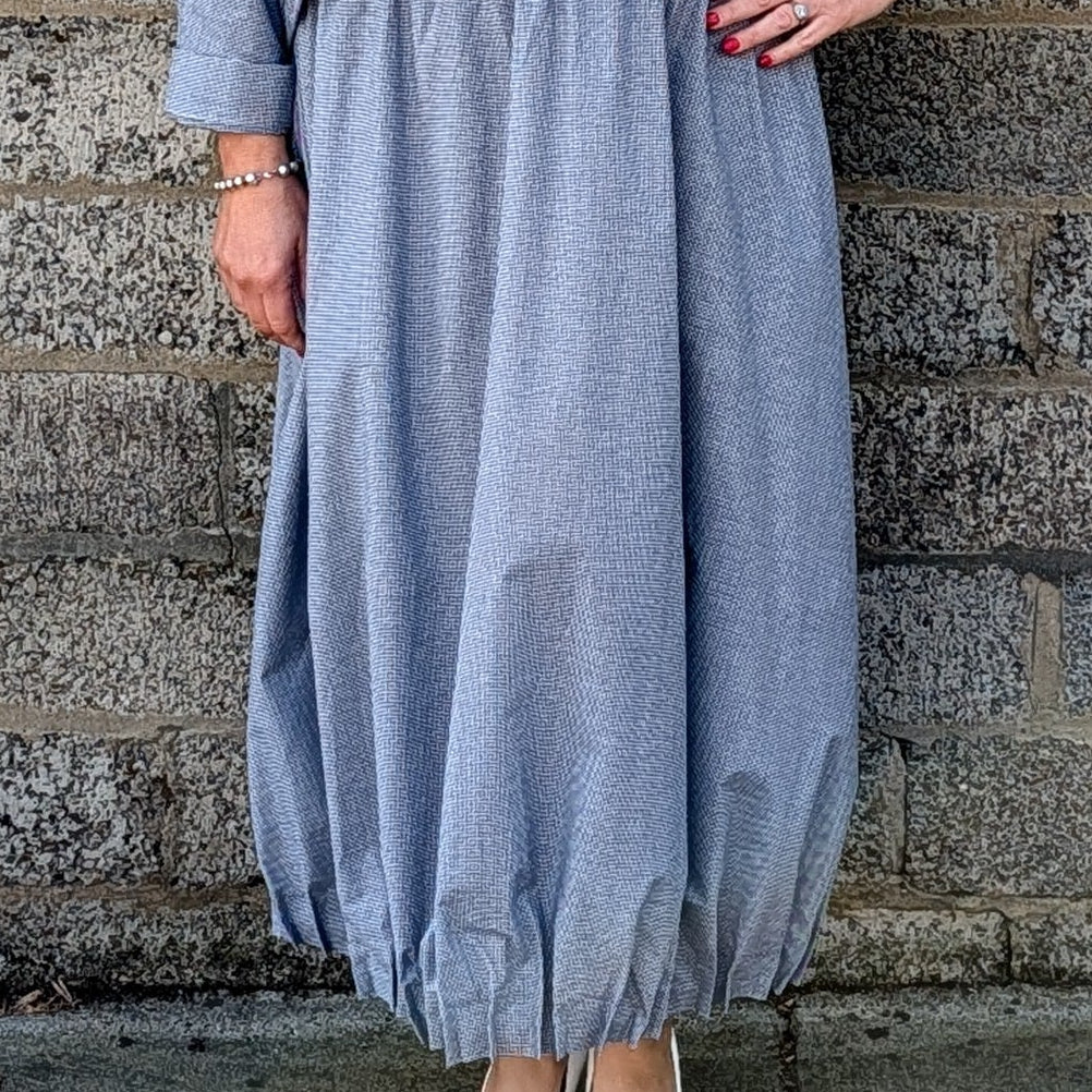light blue grey striped maxi shirt dress with a white undershirt and white pointed-toe heels.