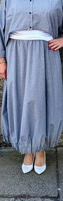 light blue grey striped maxi shirt dress with a white undershirt and white pointed-toe heels.