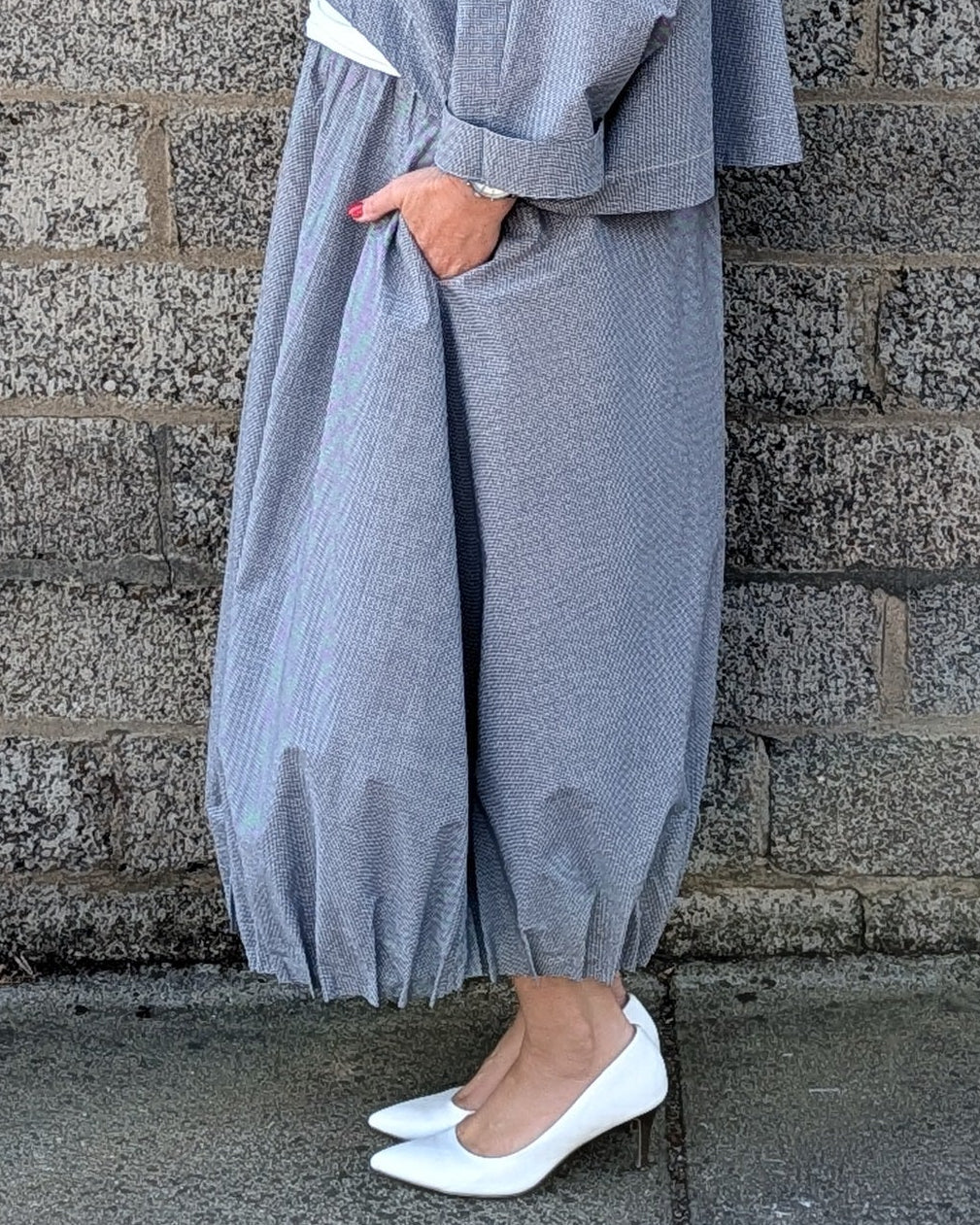 light blue grey striped maxi shirt dress with a white undershirt and white pointed-toe heels.